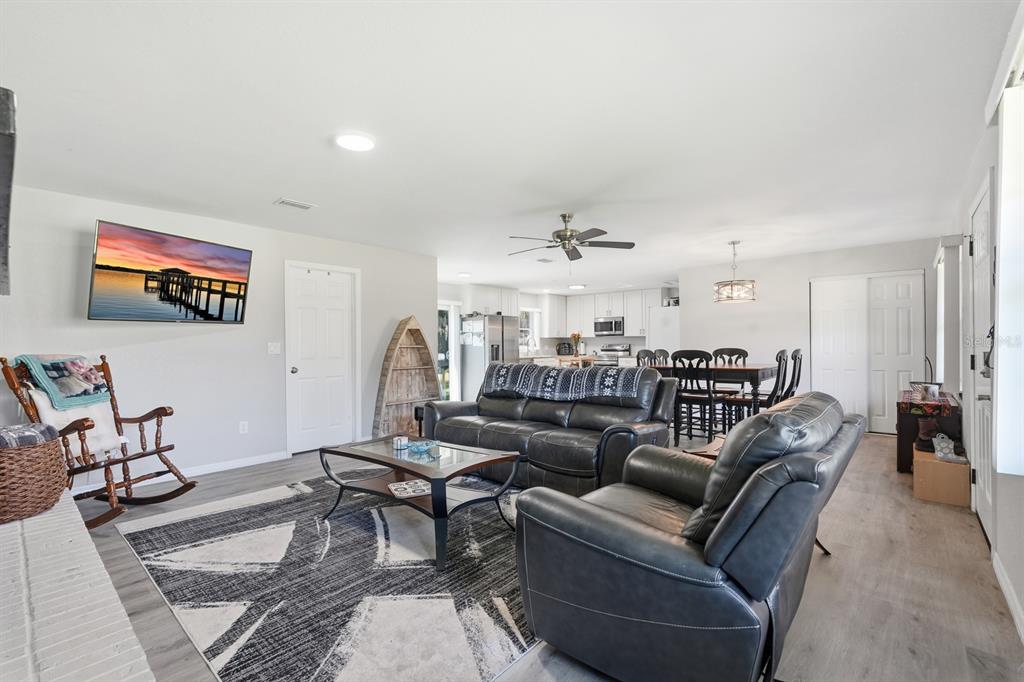 270 Wright Grove Road Oak Hill, FL 32759 - Photo 6 of 17 a living room with furniture and a ceiling fan