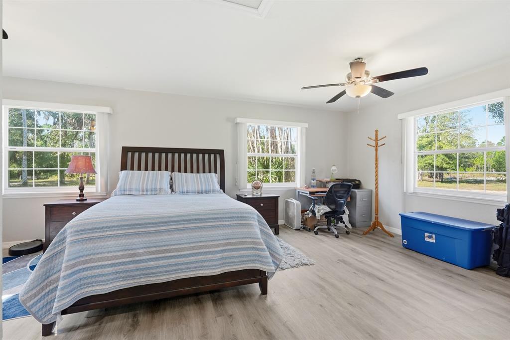 270 Wright Grove Road Oak Hill, FL 32759 - Photo 8 of 17 a bedroom with a bed and large windows