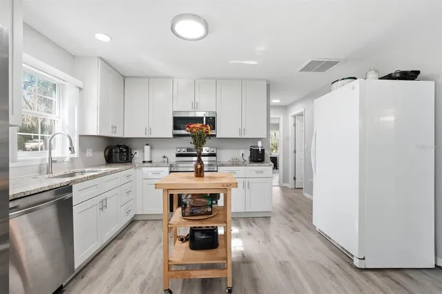 a bathroom with a granite countertop sink a toilet and a mirror
