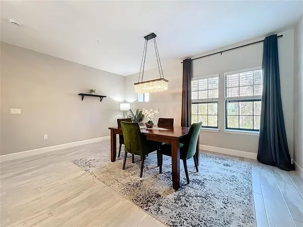 a dining room with a wooden table and chairs