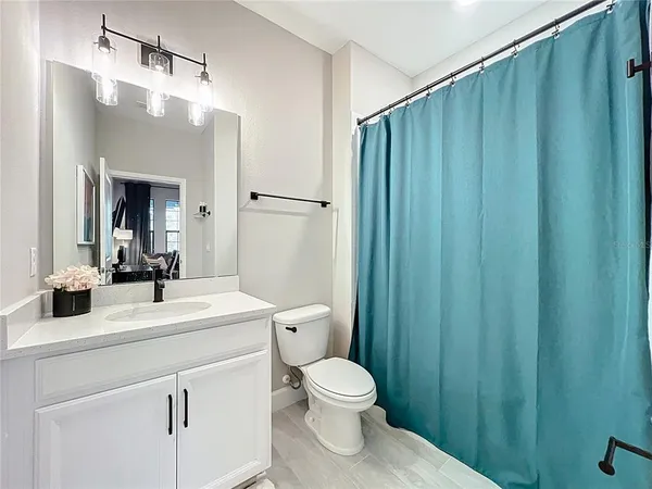 a bathroom with a toilet a sink and a mirror