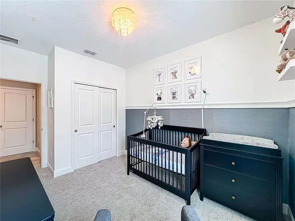 a bedroom with a bed and cabinets