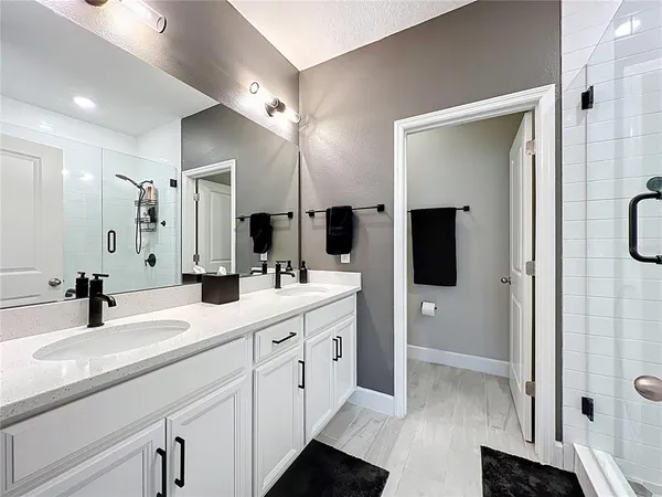 a bathroom with a double vanity sink and mirror