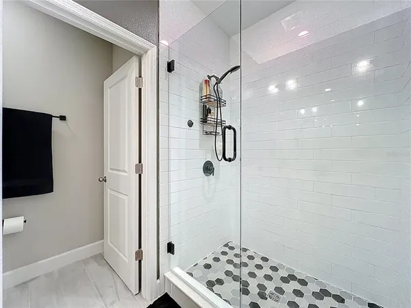 a bathroom with a shower and a sink