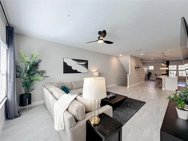 a living room with furniture and a chandelier