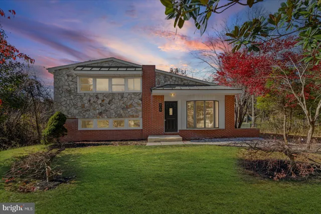 a front view of a house with a garden