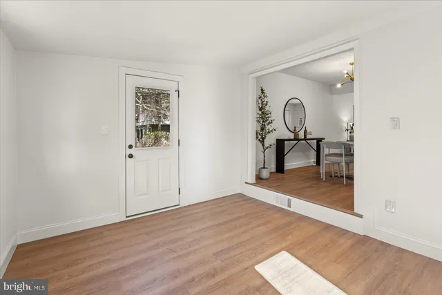 a view of a room with wooden floor and furniture