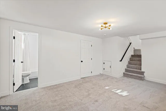 a view of an empty room with a ceiling fan