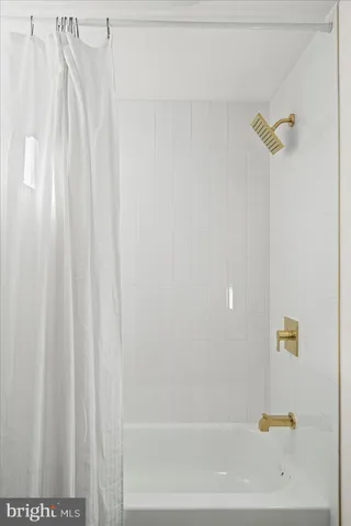 a bathroom with a shower a toilet and a sink