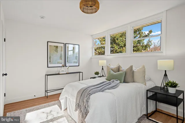 an empty room with a painting on the wall