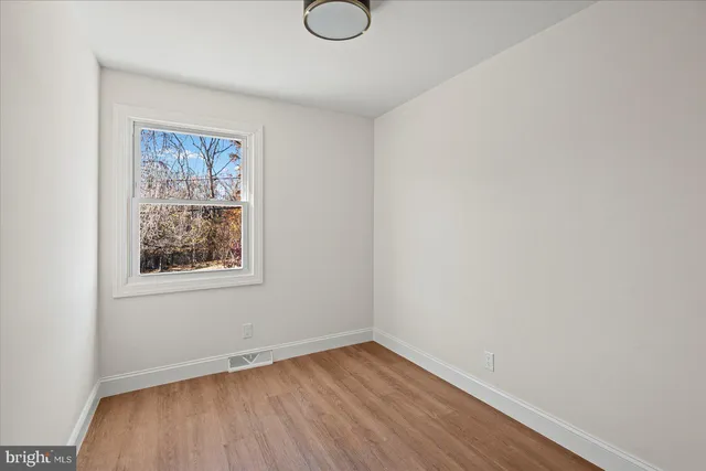 a kitchen with white cabinets and sink