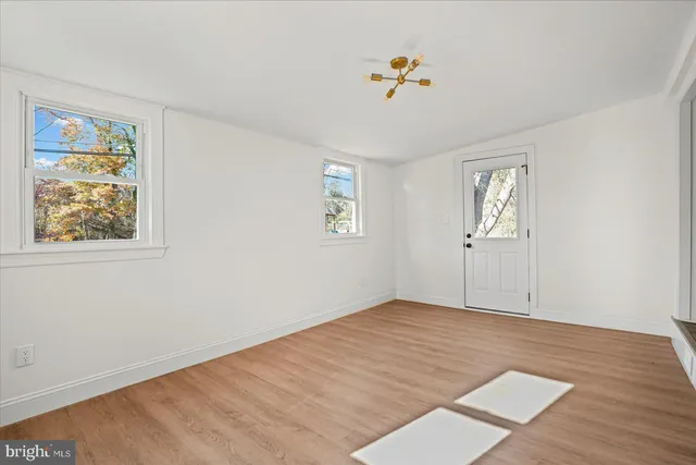 a front view of a house with a garden and trees