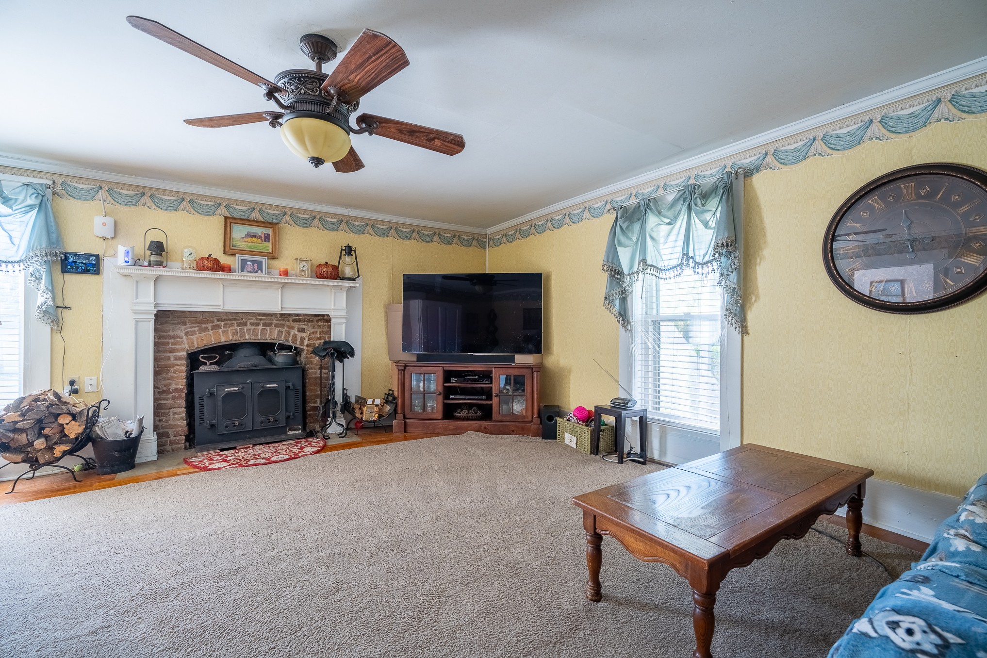 116 Ashland Road Waynesboro, TN 38485 - Photo 15 of 59 a living room with furniture a flat screen tv and a fireplace