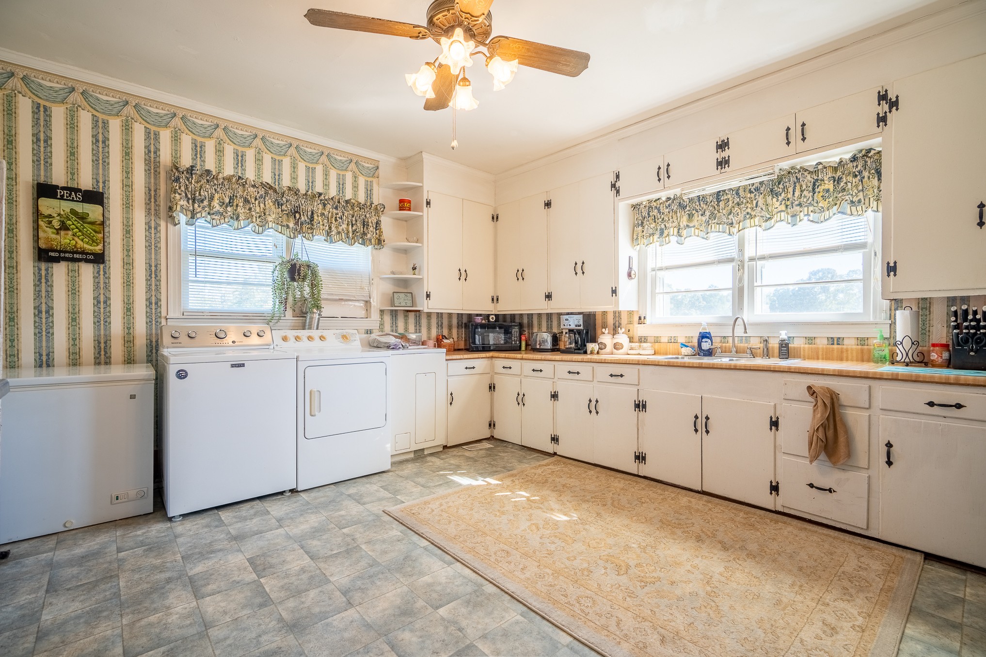 116 Ashland Road Waynesboro, TN 38485 - Photo 20 of 59 a large white kitchen with granite countertop white cabinets white appliances with a large window
