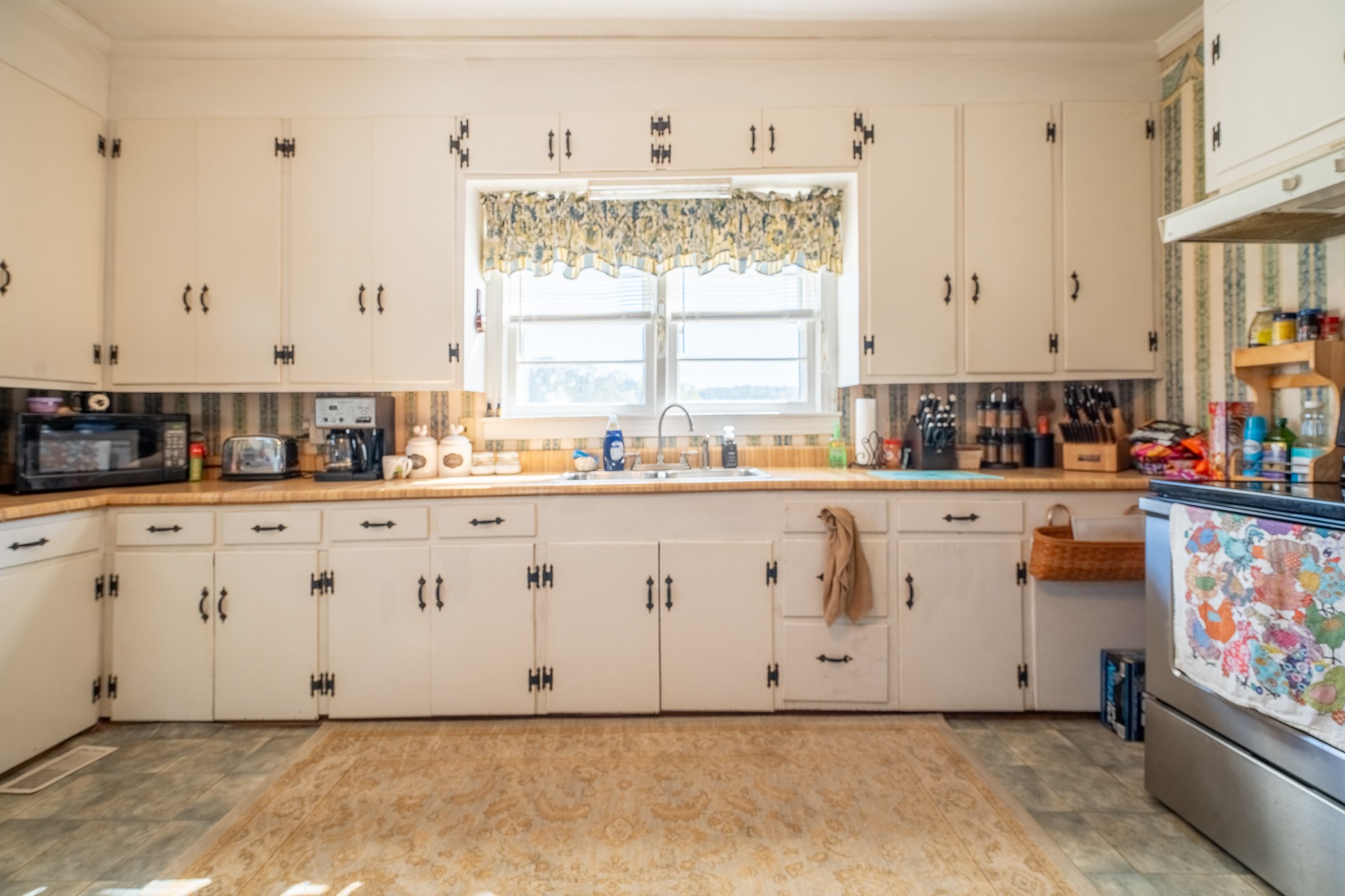 116 Ashland Road Waynesboro, TN 38485 - Photo 21 of 59 a kitchen with stainless steel appliances white cabinets and a window