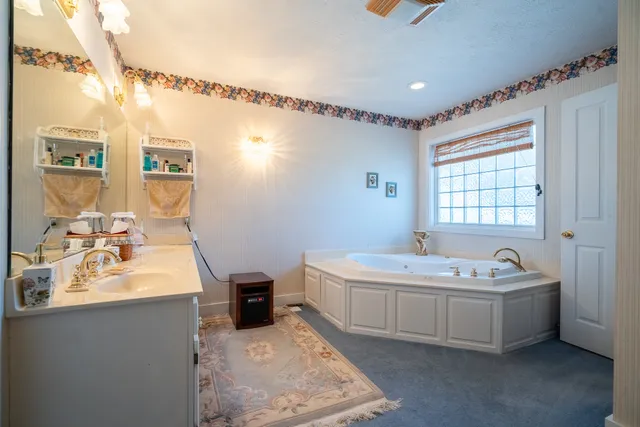 a bathroom with bathtub and window