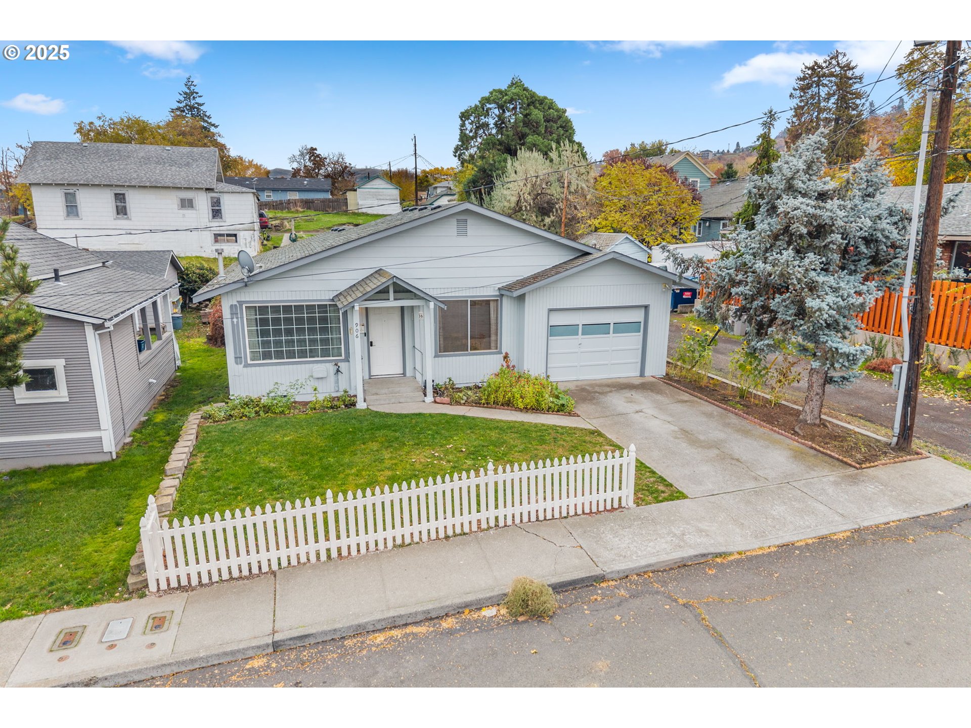 906 Garrison Street The Dalles, OR 97058 - Photo 20 of 25 a view of a house with a yard and fence
