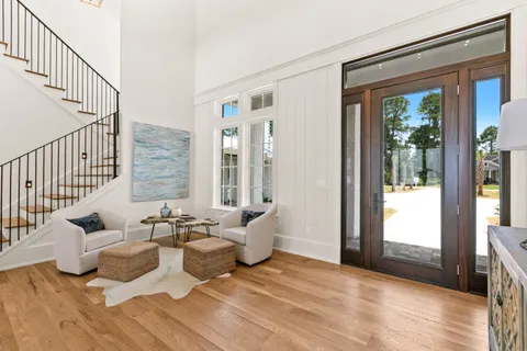 a kitchen with stainless steel appliances granite countertop a sink a stove and a wooden floors