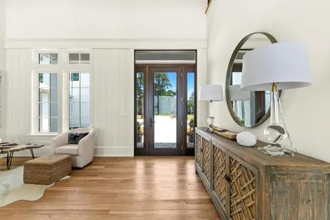 a kitchen with stainless steel appliances granite countertop a sink a stove and a wooden floors