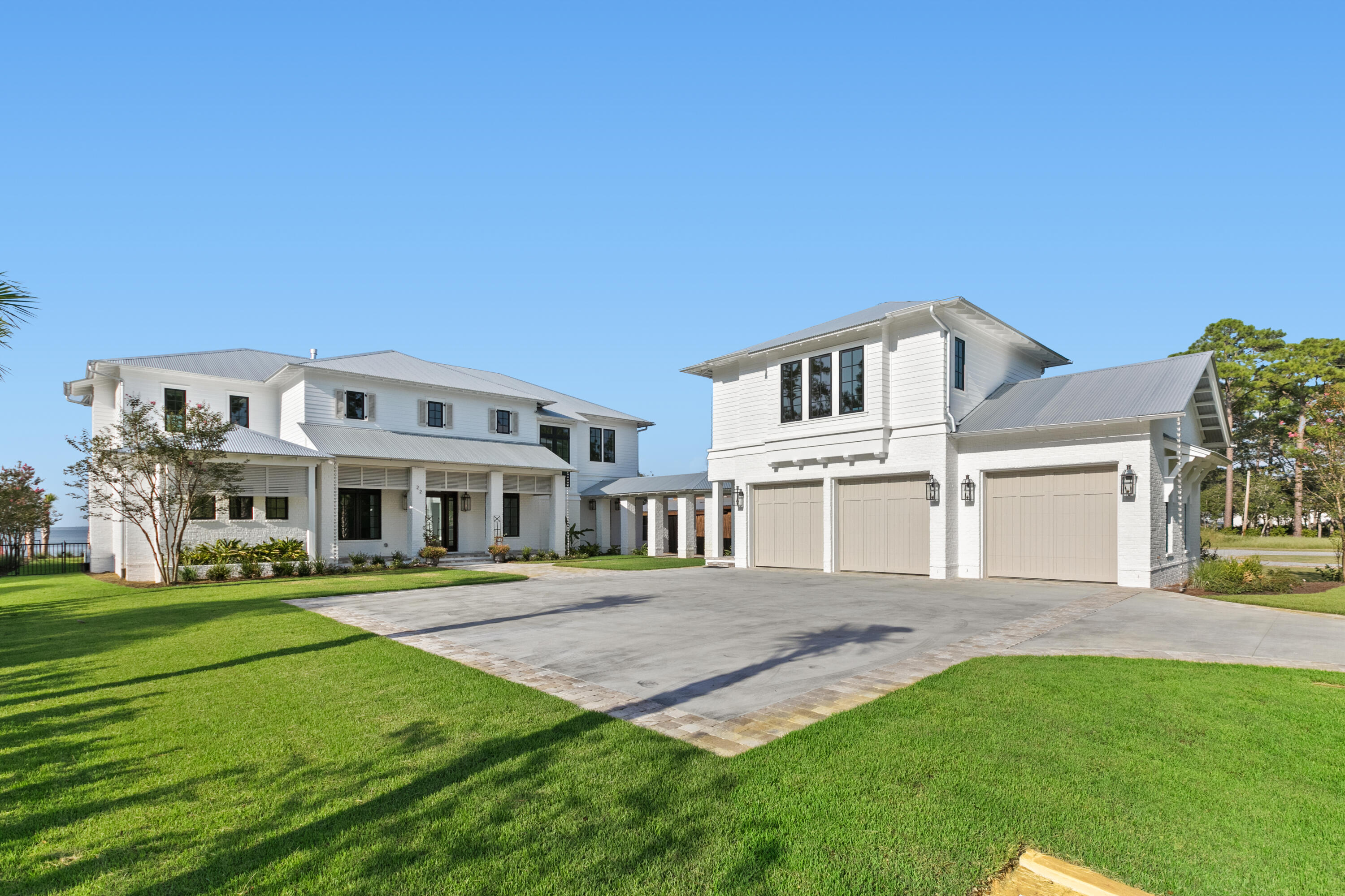 22 Carolyn Lane Santa Rosa Beach, FL 32459 - Photo 2 of 108 a front view of a house with a garden and trees