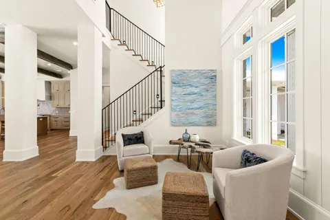 a large kitchen with kitchen island a sink dishwasher a dining table and chairs with wooden floor