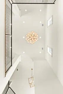 a dining room with large window and wooden floor