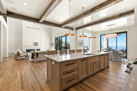 an empty room with a window and a ceiling fan