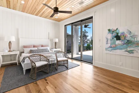 an aerial view of a house with swimming pool and outdoor seating