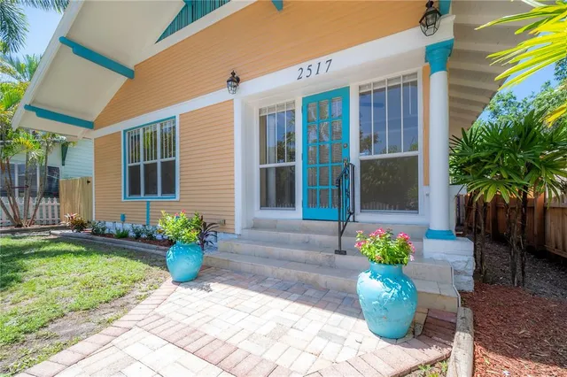 a front view of a house with potted plants