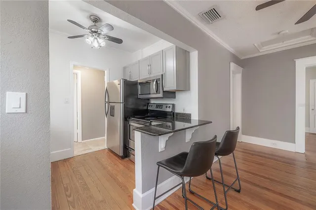 a kitchen with stainless steel appliances granite countertop a stove top oven a refrigerator a sink and dishwasher