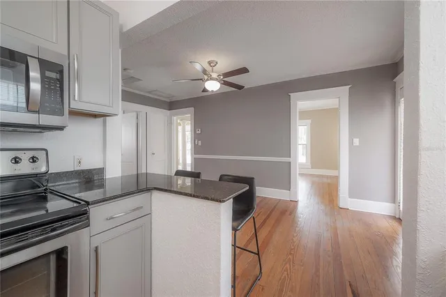 a kitchen with granite countertop a sink stainless steel appliances and cabinets