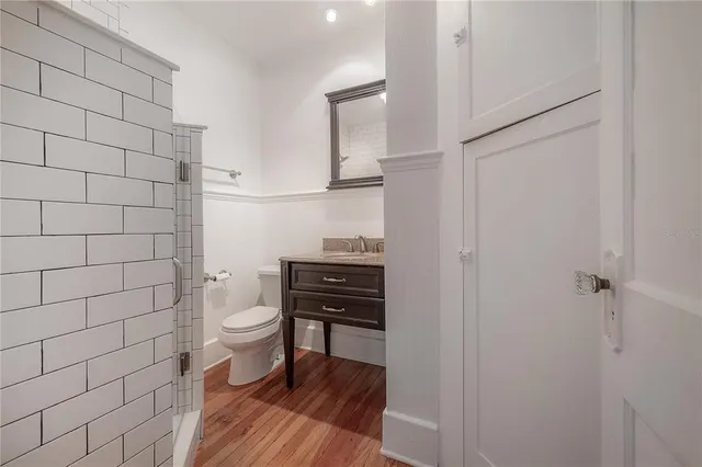 a bathroom with a toilet and a shower