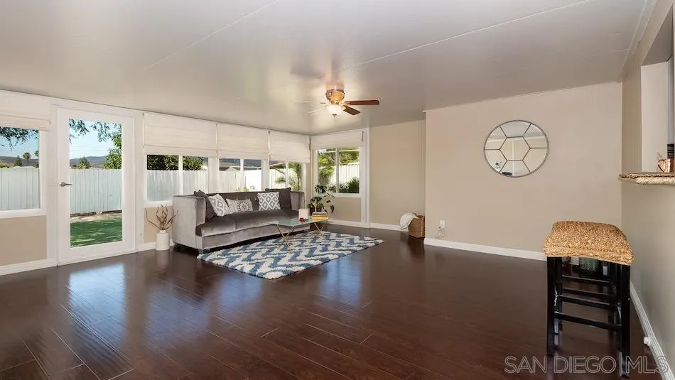 9265 Ruffin Road Santee, CA 92071 - Photo 11 of 25 a living room with furniture and wooden floor