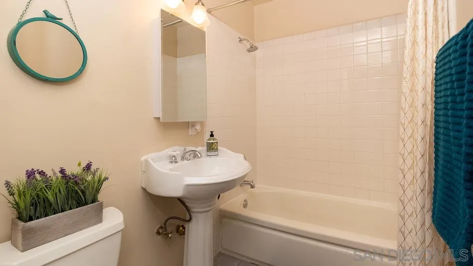 9265 Ruffin Road Santee, CA 92071 - Photo 13 of 25 a bathroom with a sink a toilet and a bathtub