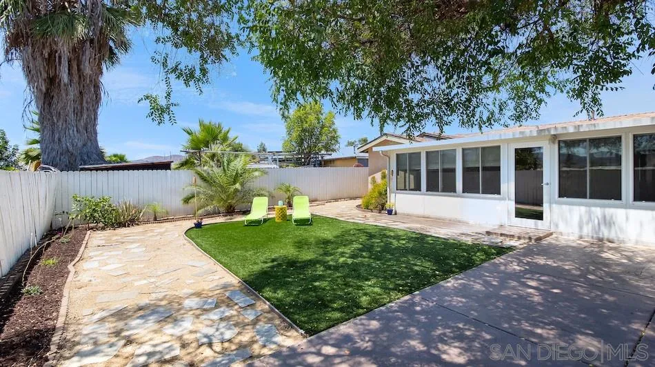 9265 Ruffin Road Santee, CA 92071 - Photo 21 of 25 a front view of a house with a garden