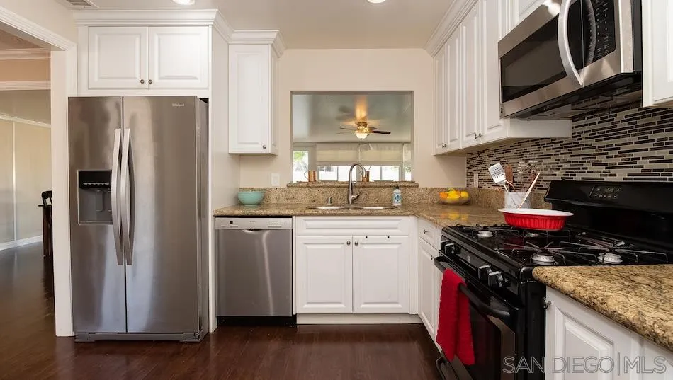 9265 Ruffin Road Santee, CA 92071 - Photo 5 of 25 a kitchen with stainless steel appliances granite countertop a refrigerator stove and sink