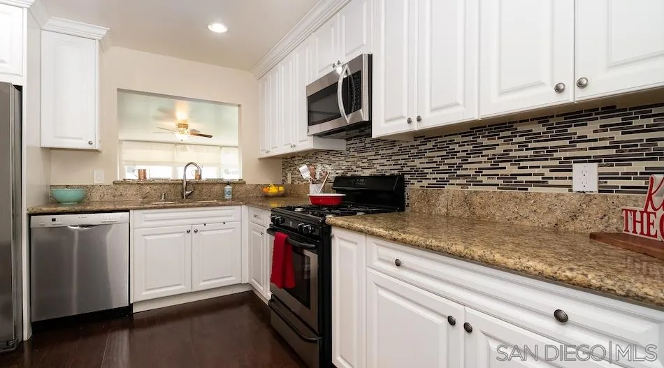 9265 Ruffin Road Santee, CA 92071 - Photo 6 of 25 a kitchen with stainless steel appliances granite countertop a sink stove and microwave