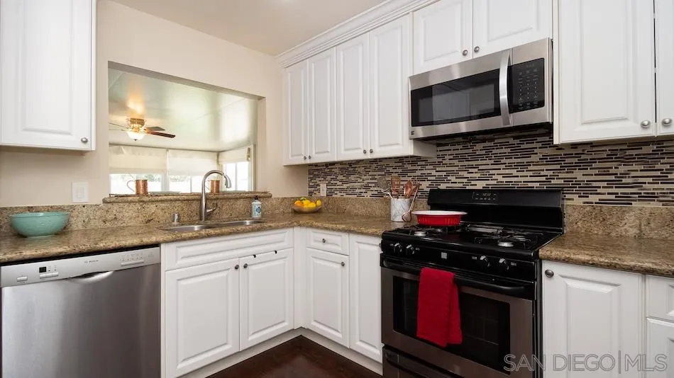 9265 Ruffin Road Santee, CA 92071 - Photo 7 of 25 a kitchen with stainless steel appliances granite countertop a stove a microwave and a sink