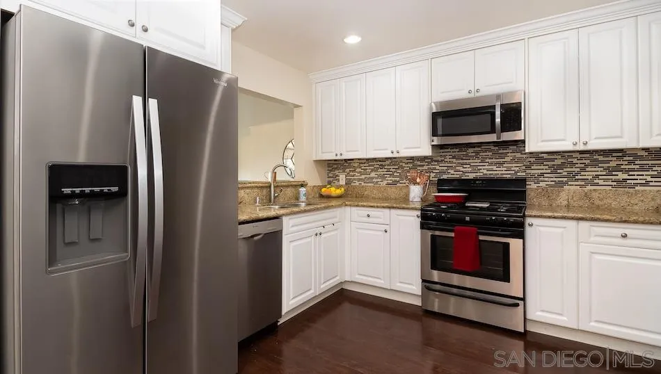 9265 Ruffin Road Santee, CA 92071 - Photo 8 of 25 a kitchen with stainless steel appliances granite countertop a refrigerator stove and microwave