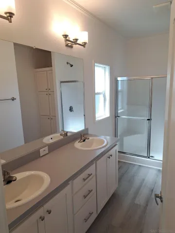 a spacious bathroom with a granite countertop sink a mirror and a