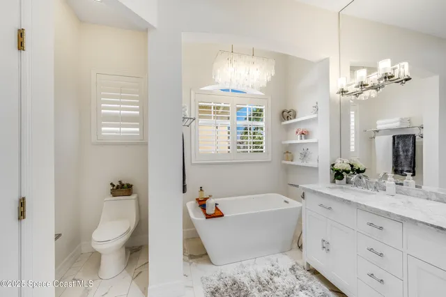 a view of a patio with a table and chairs under an umbrella