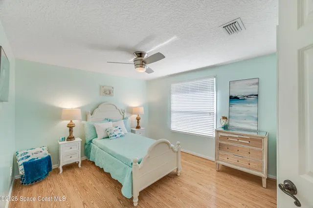 an aerial view of residential houses with outdoor space and seating