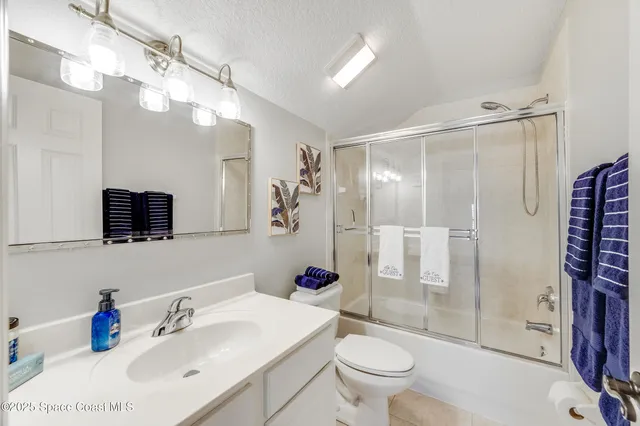 a view of a balcony with floor to ceiling windows and wooden fence