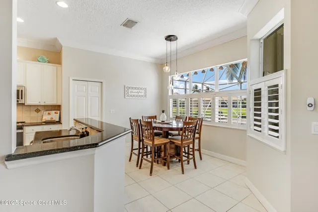 a dining room with furniture and a chandelier