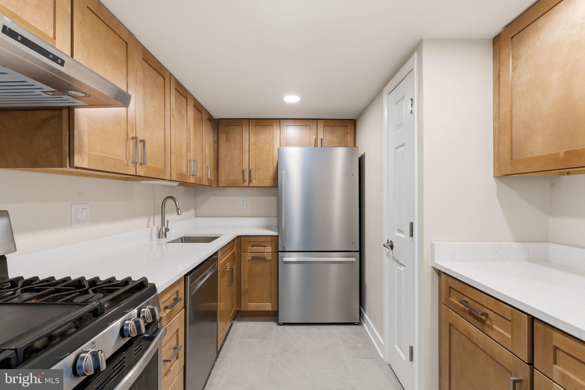a kitchen with a refrigerator a sink and a stove