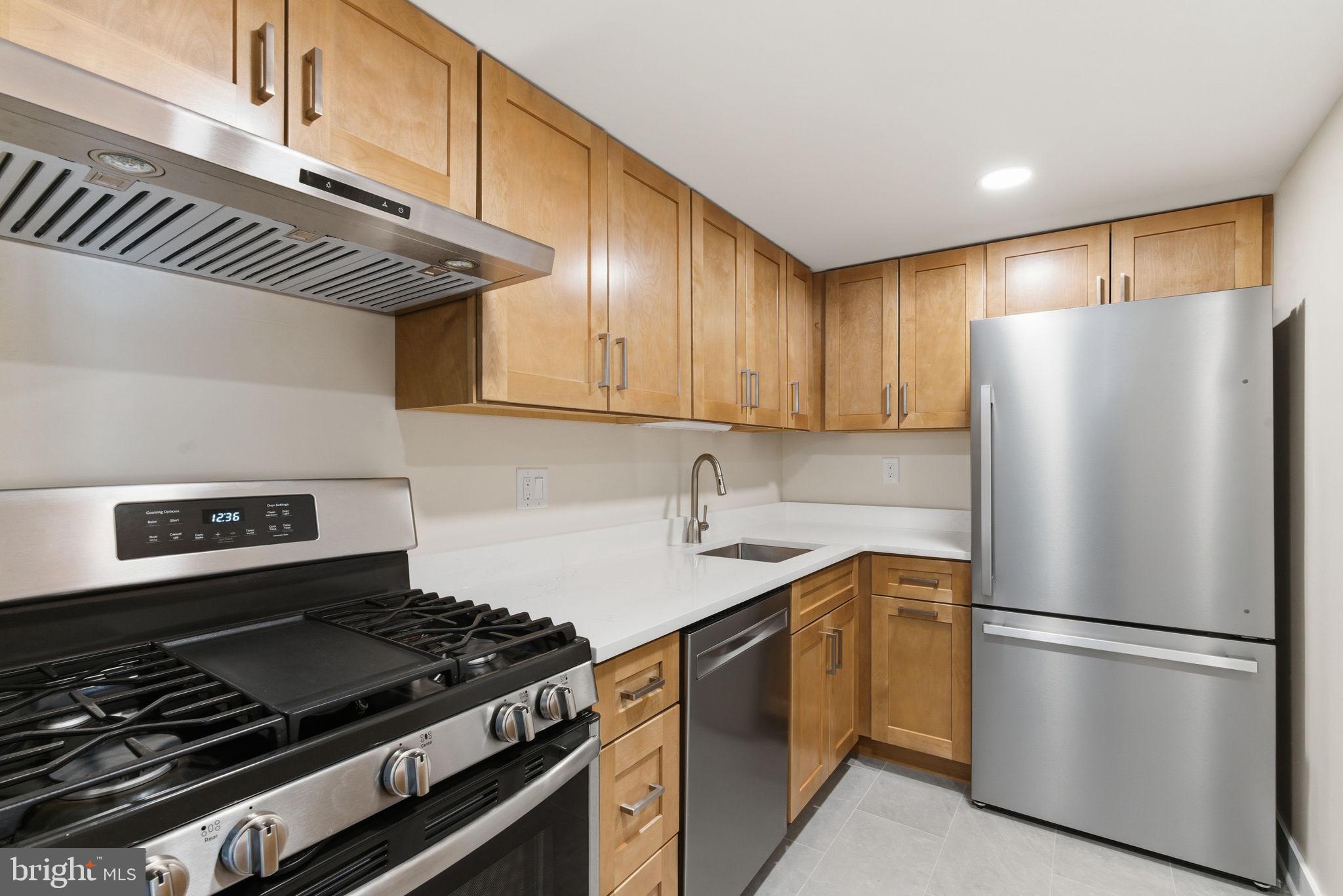 463 Old Forge Crossing Devon, PA 19333 - Photo 8 of 21 a kitchen with a refrigerator and a stove top oven