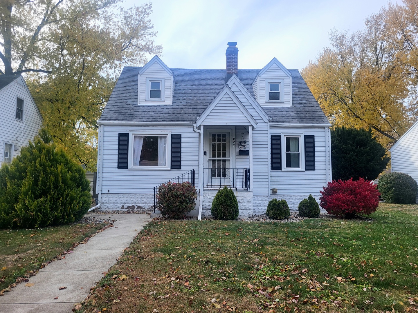 a front view of a house with a garden
