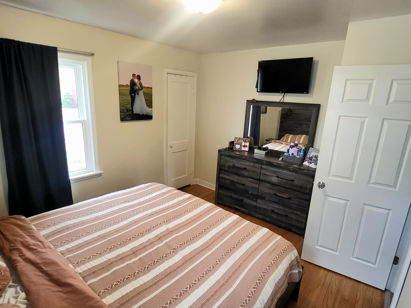 623 South Yates Avenue Kankakee, IL 60901 - Photo 8 of 17 a bedroom with a bed flat screen tv and a window