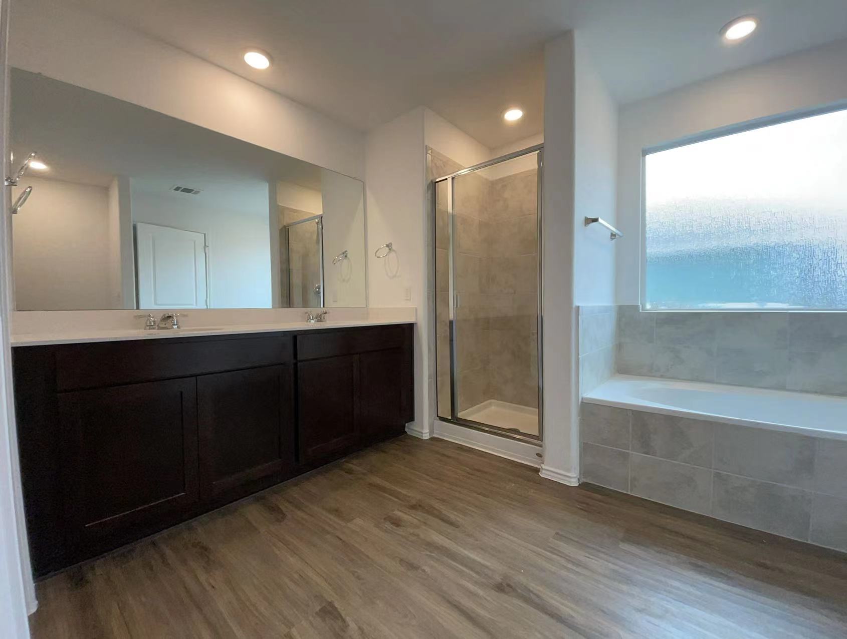 125 Madrid Kyle, TX 78640 - Photo 10 of 23 Full bathroom featuring double vanity, a stall shower, a bath, light wood-style flooring, and recessed lighting