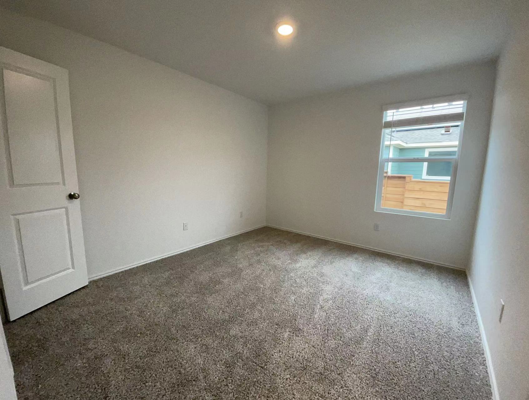 125 Madrid Kyle, TX 78640 - Photo 14 of 23 Spare room with dark colored carpet and baseboards
